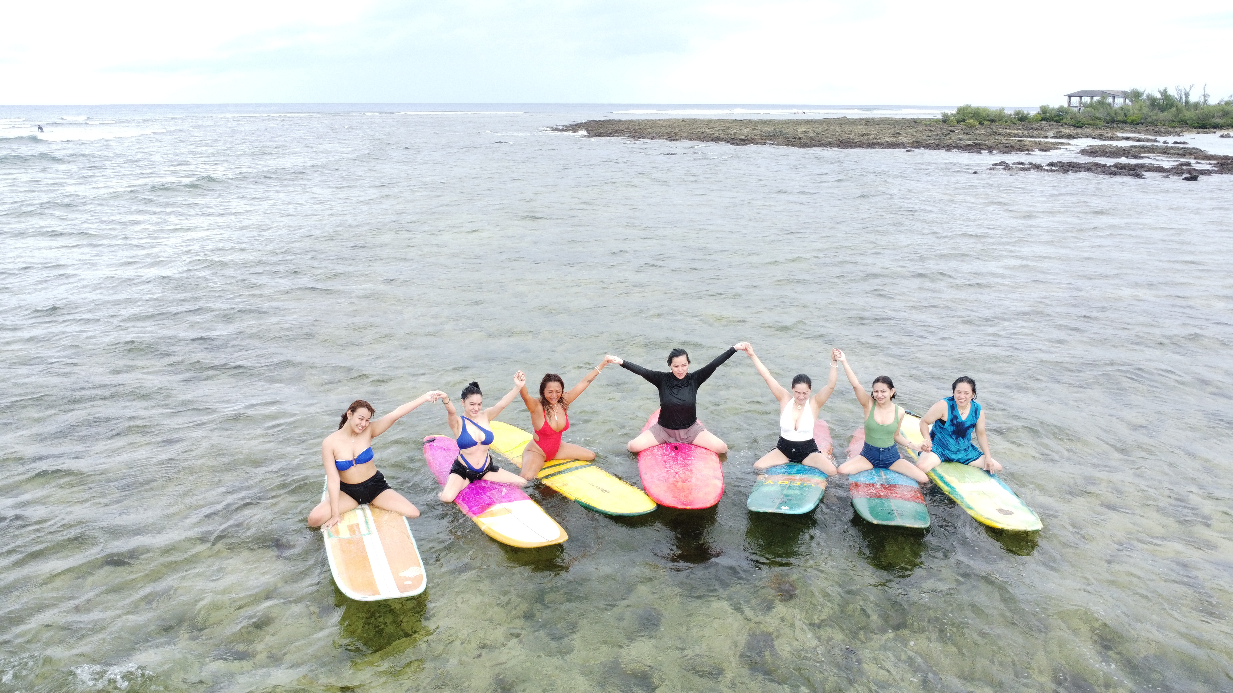 Women sitting on surfboards in Siargao
